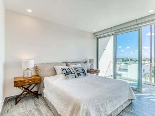 Bedroom with private balcony and ocean/city views