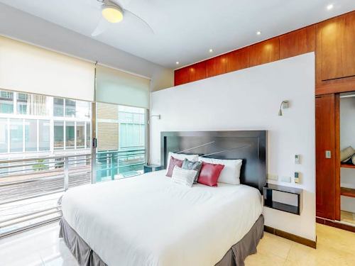 Bedroom with king-size bed and natural light.