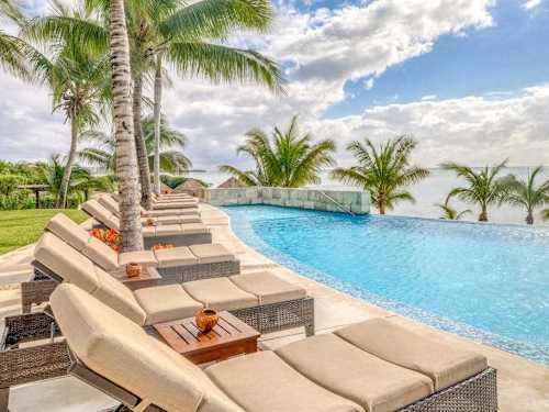 Shared beachfront infinity pool steps from the sand
