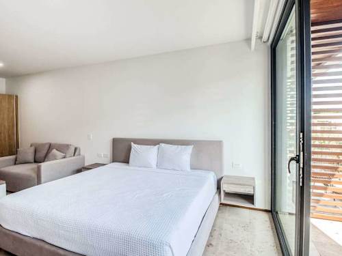 Sleeping area with King bed and natural light