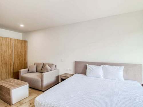 Studio sleeping area with plush King-size bed