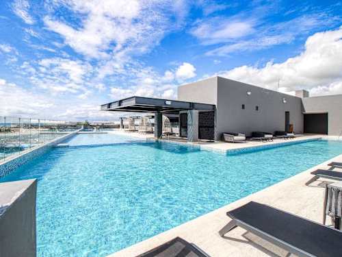 Shared rooftop pool with ocean views