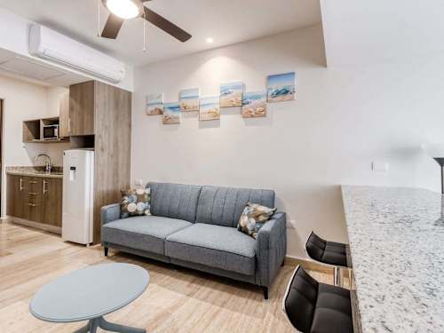 Seating area with sofa and balcony access