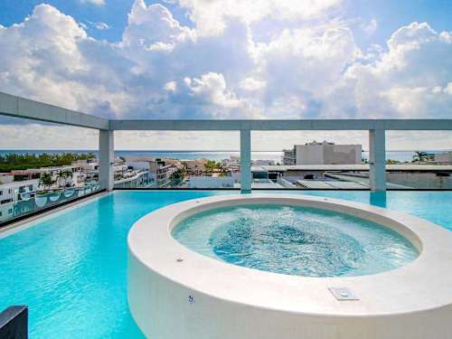 Shared rooftop pool and jacuzzi with ocean views