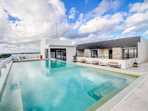 Shared rooftop pool and lounge area