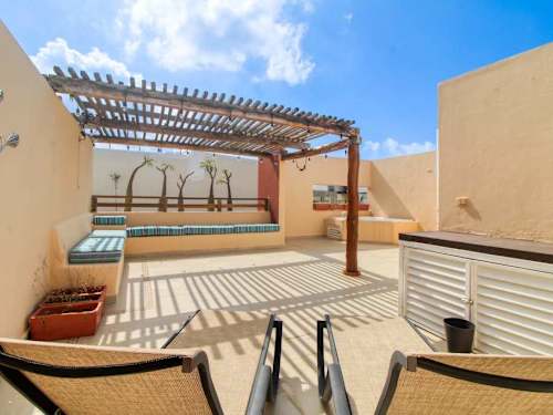 Private rooftop sun deck with loungers