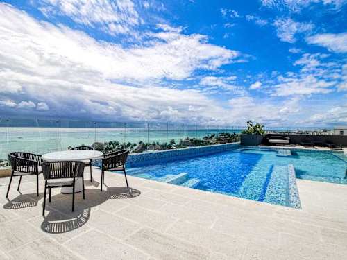 Shared rooftop pool with panoramic ocean views