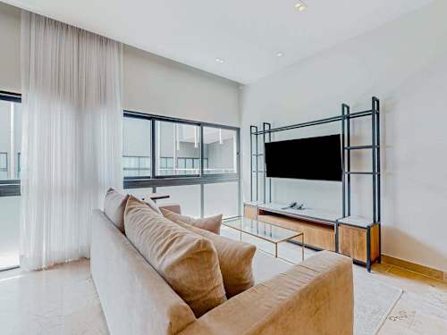 Living room with smart TV and plush sofa