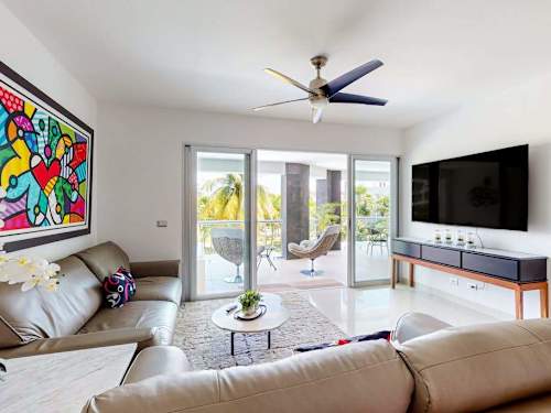 Living room with balcony doors and sea views