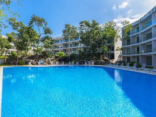 Shared pool surrounded by tropical gardens