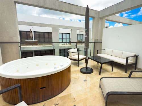 Shared rooftop infinity pool with ocean views