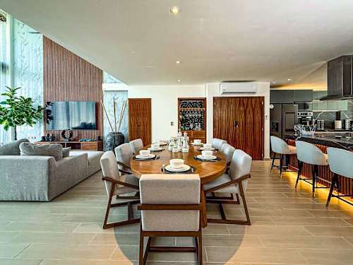 Open living and dining space with warm wood accents and modern design, easy indoor living for the whole group