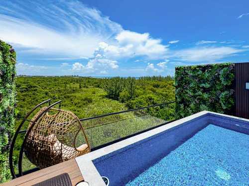 Rooftop pool with sweeping jungle views, the perfect vantage point to unwind at any hour