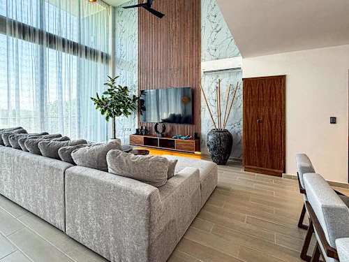 Bright, airy living room with a plush sofa and clean lines, a relaxed spot to unwind after a day by the sea