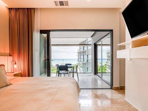 Open living and dining area opening to the ocean-view balcony
