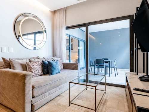 Bright living room with smart TV and ocean-view balcony