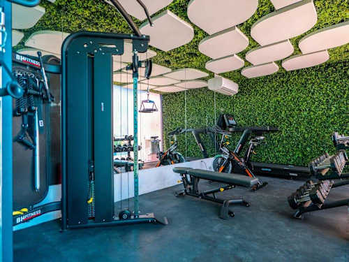 Shared rooftop gym and lounge with pool view