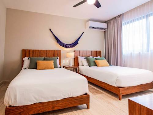 Second bedroom with two double beds and a hammock