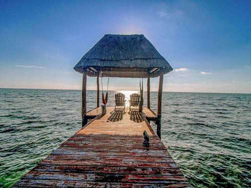 Private beachfront palapa deck over the water with loungers