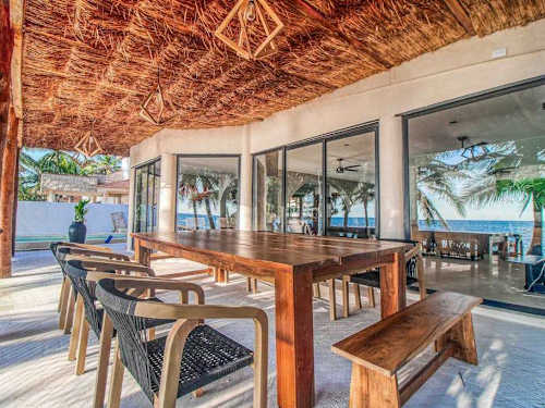 Covered outdoor dining terrace with sea breeze