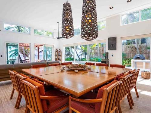 Large indoor dining table seating the whole group, beside the kitchen