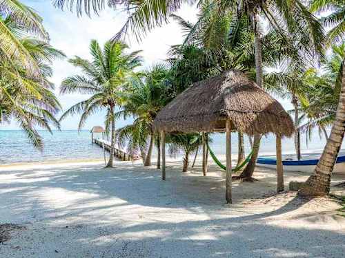 Direct beach access - the villa seen from the white-sand shoreline