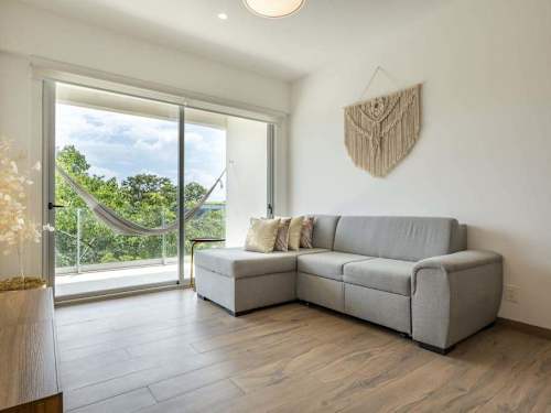 Bright living area with sofa and balcony