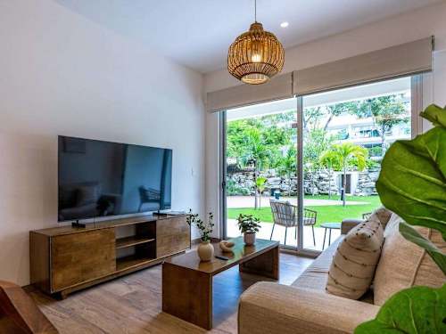 Living room with smart TV and balcony
