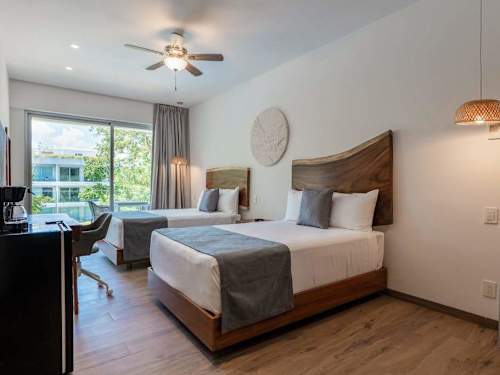 Bright king bedroom with a flat screen and large window, an easy space to recharge