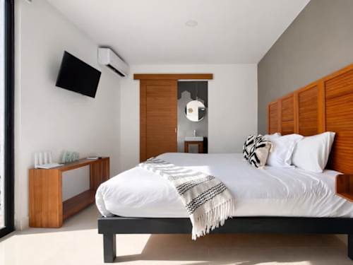 King bed with upholstered headboard and soft lighting