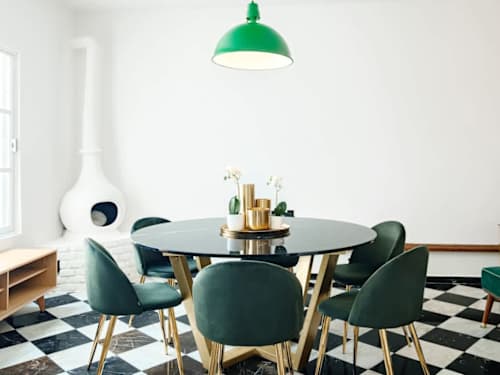 Chic dining nook with emerald chairs and checkerboard floors, a design-forward spot for shared meals