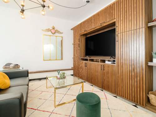 Elegant living area with a wood-paneled media wall, unwind after a day in Polanco