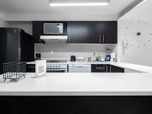Functional kitchen with full appliances and bright counters, easy meals in a stylish space