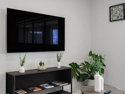 Smart TV mounted above a sleek console, settle in for a cozy night of streaming