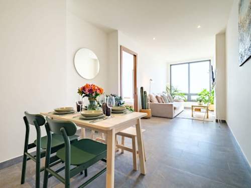Open dining and living with a set table, bright and made for meals with a view