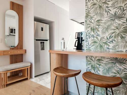 Chic breakfast bar with wood stools and a full fridge, grab coffee and start your day
