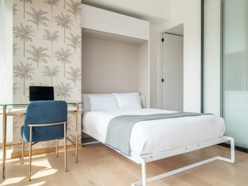 Bright bedroom with a comfy bed and a sunny work chair, wake up to natural light