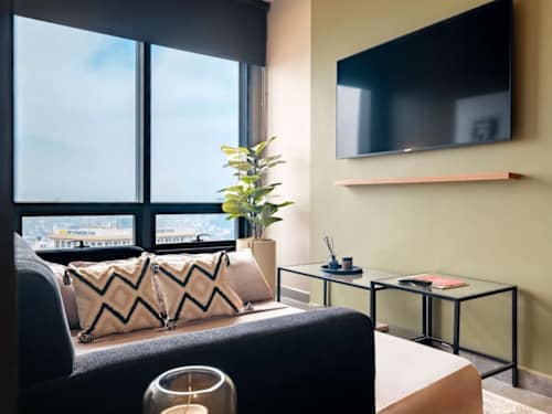 Comfortable lounge corner with a wall-mounted TV and soft seating, easy nights in