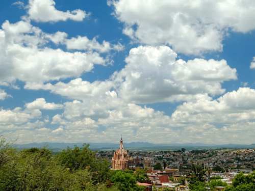 Panoramic rooftop views across the highland rooftops toward the historic parish, a breathtaking daily backdrop