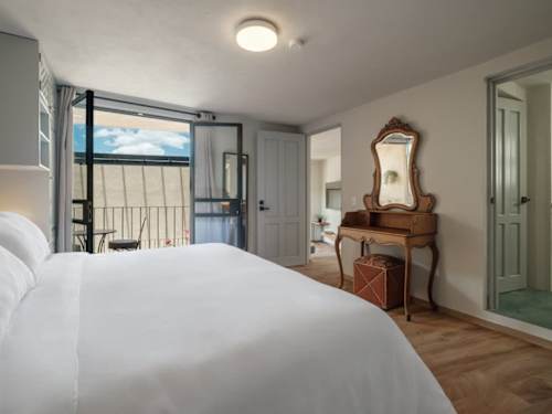 Charming bedroom pairing a comfy bed with an antique dresser, character and comfort in equal measure