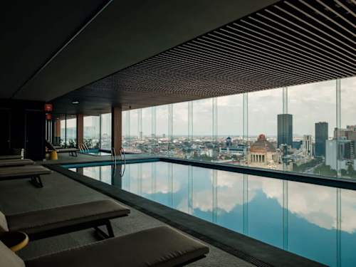 Skyline lap pool stretching along glass walls, do your laps with the whole city as your backdrop
