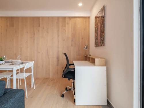 Handy workspace with a desk and chair beside the dining nook, comfortable for remote days