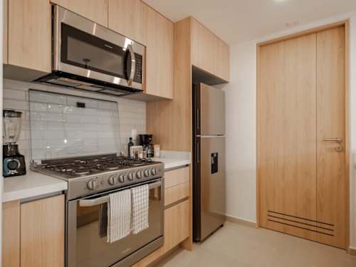 Full kitchen with a gas range, microwave and fridge, everything you need to cook for the family