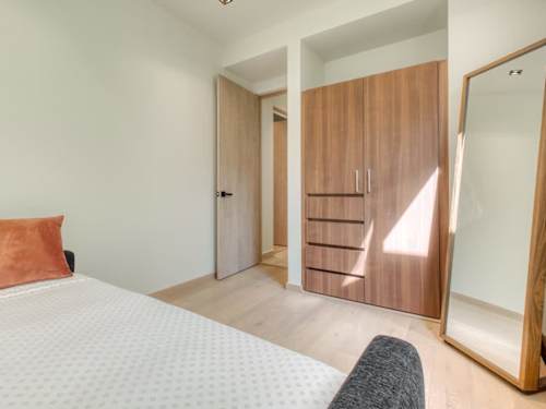 Airy bedroom with a full-length mirror and generous wardrobe, thoughtful storage for a longer, comfortable stay