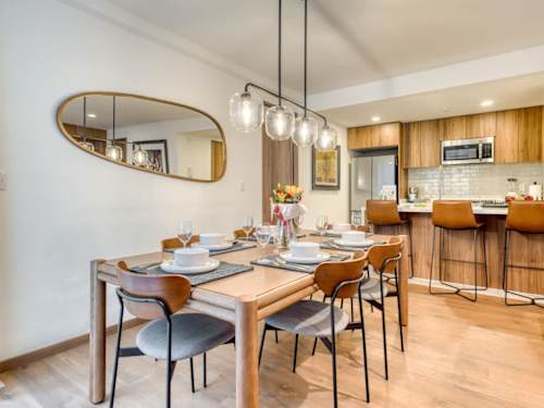 Inviting dining nook beside the kitchen with designer pendants, gather for a home-cooked meal