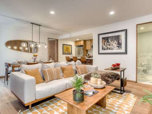 Bright, open living area with a comfy sofa and warm pendant light, relaxed evenings after exploring Condesa