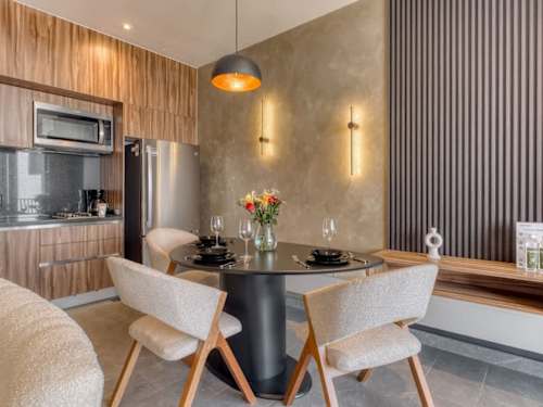 Chic dining nook beside a full kitchen, coffee and meals with a designer touch