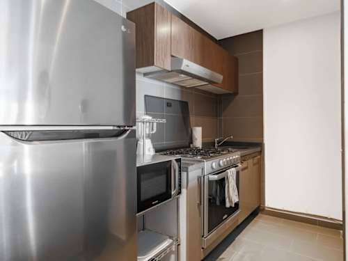 Fully equipped kitchen with stainless fridge and full stove, everything you need to cook in
