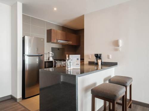 Modern kitchen with a breakfast bar and stools, morning coffee steps from Masaryk