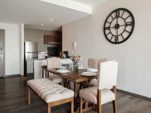 Warm dining area with the kitchen close by, gather for a home-cooked meal near Parque Lincoln